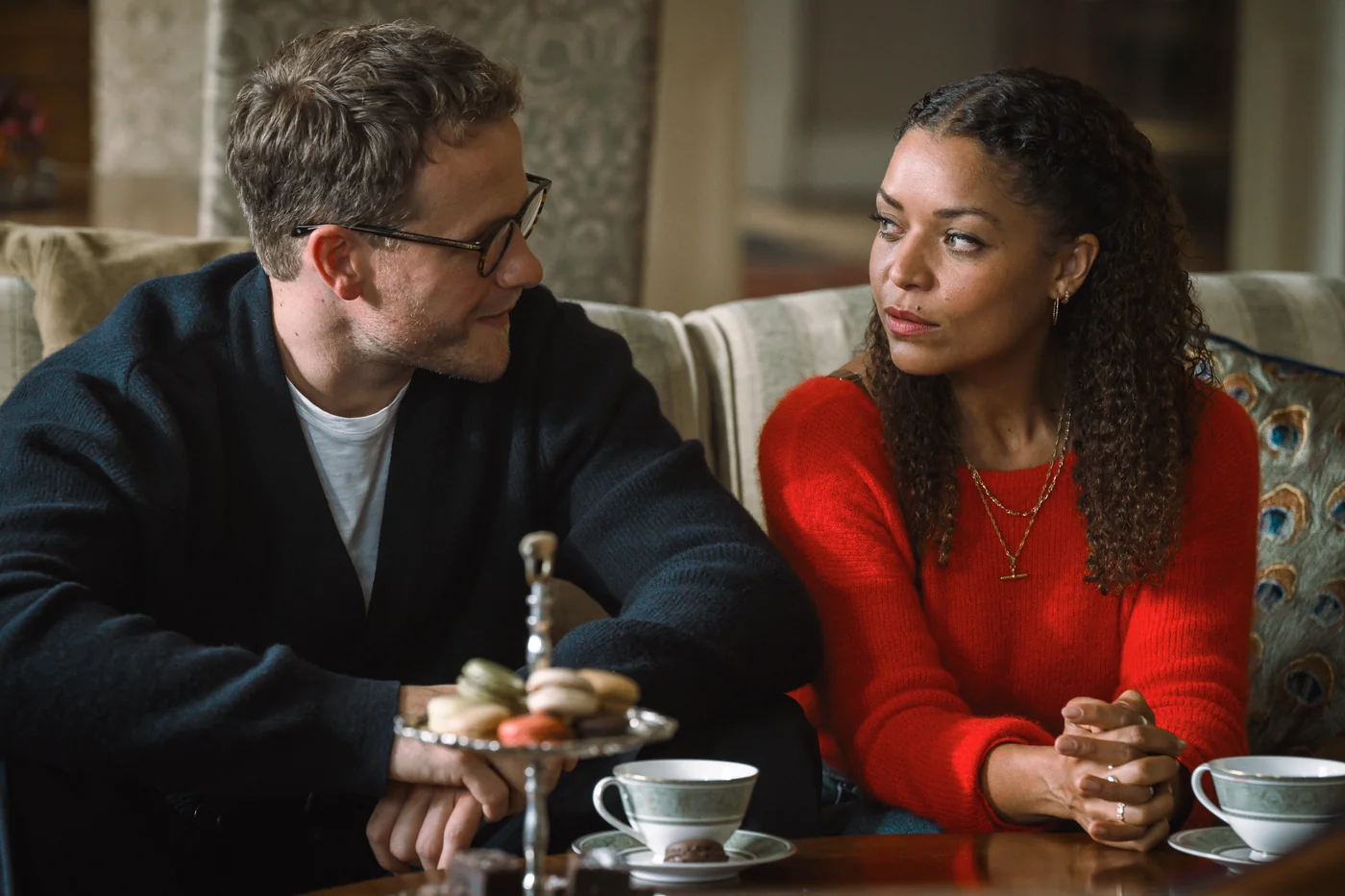 Josh Dylan and Antonia Thomas as Tommy and Tuppence sharing afternoon tea
