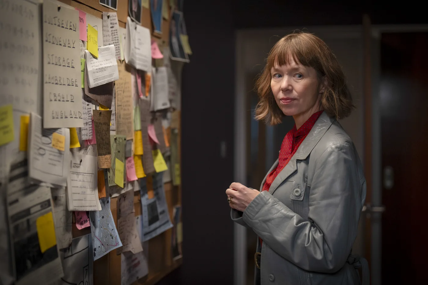 Anna Maxwell Martin as Lucy investigating a case board in Ludwig Season 2