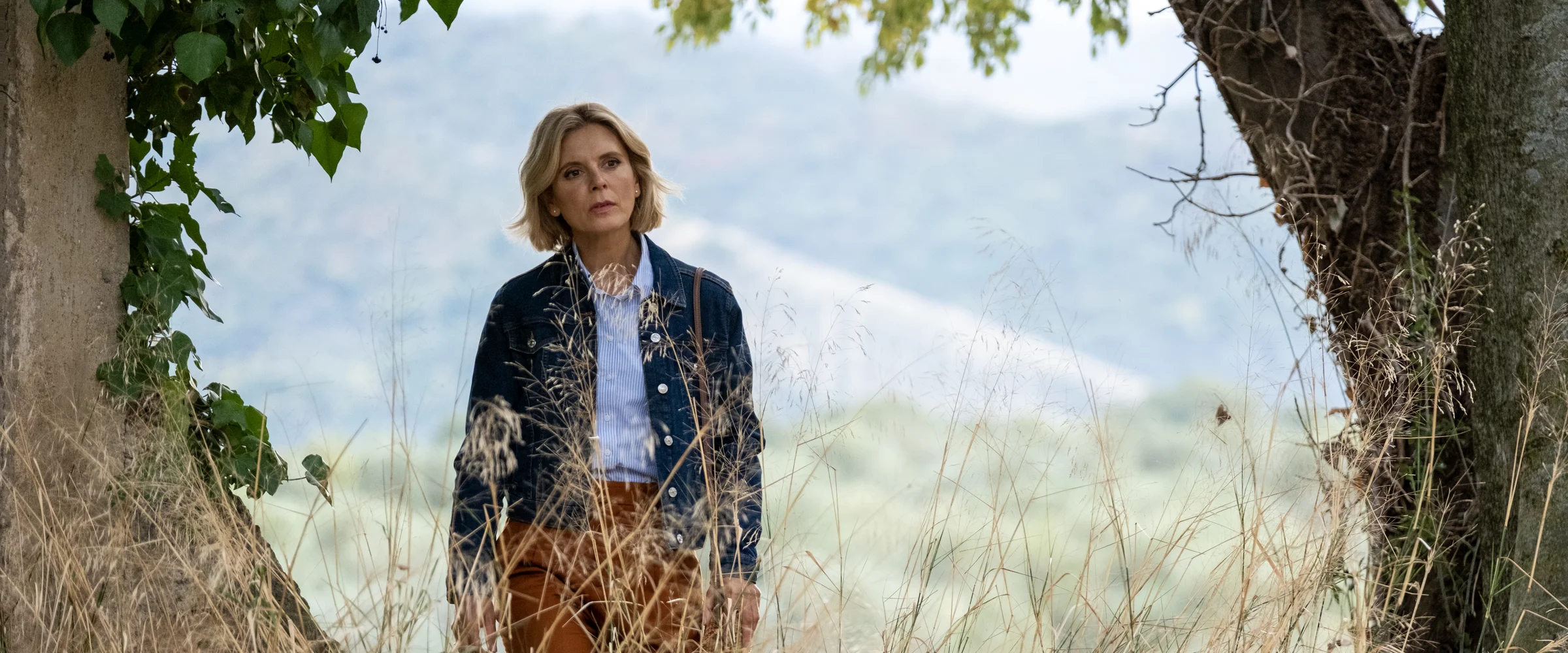 Emilia Fox as Sylvia Fox walking through the golden Umbrian countryside