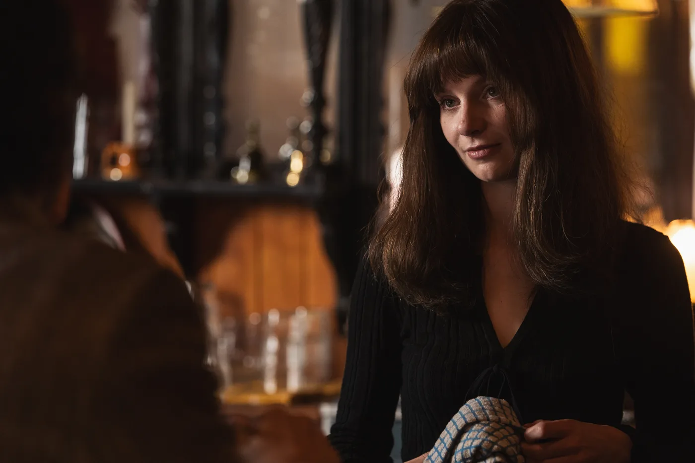 Lola Petticrew as Cushla behind the bar of the Anchor in Trespasses