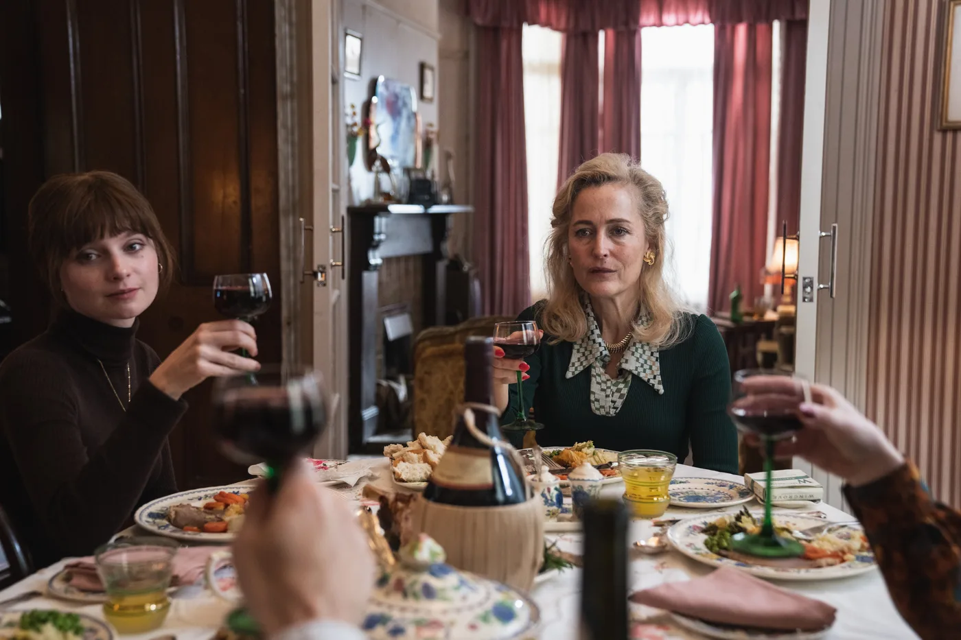 Gillian Anderson as Gina and Lola Petticrew as Cushla at a family dinner in Trespasses